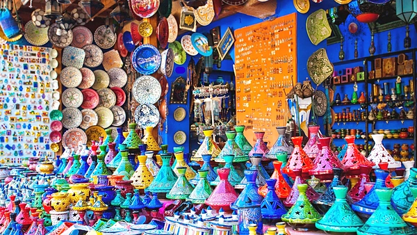 Échoppe de souk débordant de tajines et de plats en céramique peints de toutes les couleurs