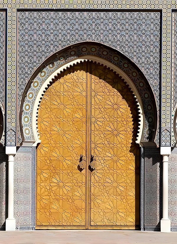 Golden royal palace door framed with zellige tilework
