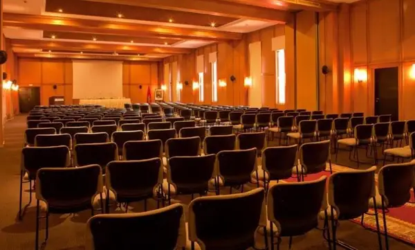 Large wood-panelled conference room set theatre-style, Marrakech