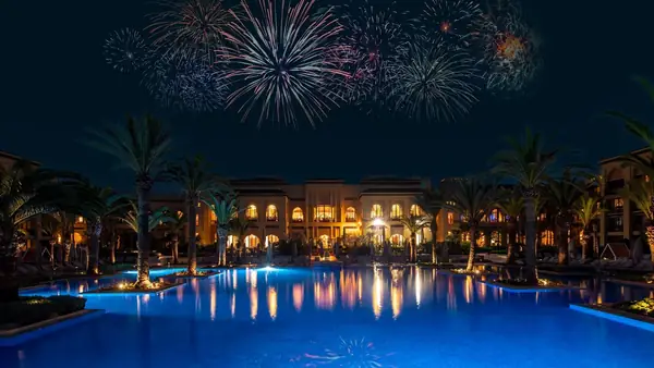 Palace pool lit up under fireworks